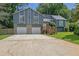 Exterior of two story house with stone and siding, 2 car garage and well manicured yard at 2673 Deerfield Sw Cir, Marietta, GA 30064