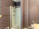 Bathroom with a shower, toilet, and sink; wallpapered walls and a gold towel rack at 775 Brand South Trl, Lawrenceville, GA 30046