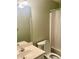 Standard bathroom with a single sink vanity, toilet, and a shower/tub combo with a white shower curtain at 775 Brand South Trl, Lawrenceville, GA 30046