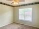 Bedroom with light-colored walls, brown carpet, ceiling fan, and a window that shows neighborhood foliage at 775 Brand South Trl, Lawrenceville, GA 30046