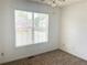 Bedroom with light-colored walls, brown carpet, and a window that shows a view of the neighborhood at 775 Brand South Trl, Lawrenceville, GA 30046
