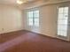 Spacious bedroom featuring a large window offering lots of natural light, neutral walls, and a ceiling fan at 775 Brand South Trl, Lawrenceville, GA 30046