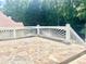 Decking made of flagstone and a white railing, with lush green foliage in the background at 775 Brand South Trl, Lawrenceville, GA 30046