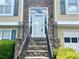 Close-up of the home's entrance, featuring a stone stairway and a white front door at 775 Brand South Trl, Lawrenceville, GA 30046