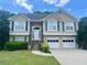 Charming two-story home featuring a manicured lawn, stone accents, and a two-car garage at 775 Brand South Trl, Lawrenceville, GA 30046