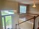 Bright foyer with hardwood floors, chandelier, and view of the front yard through a large window at 775 Brand South Trl, Lawrenceville, GA 30046