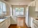 Kitchen with white cabinets, stainless sink, and view to the kitchen nook at 775 Brand South Trl, Lawrenceville, GA 30046