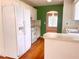 Kitchen showcasing white appliances, ample counter space, and access to another room at 775 Brand South Trl, Lawrenceville, GA 30046