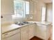 Close-up of the kitchen sink with white cabinets and access to the kitchen nook at 775 Brand South Trl, Lawrenceville, GA 30046