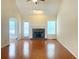 Bright living room featuring a stone fireplace, hardwood floors, and natural light at 775 Brand South Trl, Lawrenceville, GA 30046
