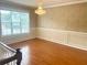Living room showcasing hardwood floors and a large window providing ample natural light at 775 Brand South Trl, Lawrenceville, GA 30046