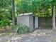 Backyard shed offering extra storage space, nestled amongst the trees and a fenced boundary at 775 Brand South Trl, Lawrenceville, GA 30046