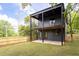 Spacious backyard featuring a wood fence, lush lawn, and an outdoor patio with black supports at 104 Meldon Ave, Atlanta, GA 30315