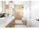 Modern bathroom with dual sinks, floating vanity, sleek fixtures, and a glass-enclosed shower at 104 Meldon Ave, Atlanta, GA 30315