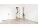 Bright bedroom showcasing modern floors, a glimpse into an ensuite bath, and a second door at 104 Meldon Ave, Atlanta, GA 30315