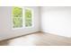 Empty bedroom with large windows, white walls, and light wood floors at 104 Meldon Ave, Atlanta, GA 30315