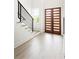 Bright foyer featuring light wood floors, a staircase, and modern front doors at 104 Meldon Ave, Atlanta, GA 30315