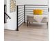Hallway with sleek horizontal railing and bench with yellow pillow at 104 Meldon Ave, Atlanta, GA 30315