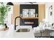 Modern kitchen featuring a sleek island, a black faucet, and open layout to the living room with a fireplace at 104 Meldon Ave, Atlanta, GA 30315