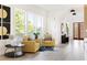 Bright living room featuring neutral walls, light hardwood floors, and gold accent chairs at 104 Meldon Ave, Atlanta, GA 30315