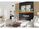 Inviting living room featuring sleek fireplace, hardwood floors and designer furnishings at 104 Meldon Ave, Atlanta, GA 30315