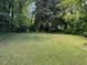 Sprawling backyard with lush greenery, a shed, and perimeter fencing at 3127 Latona Sw Dr, Atlanta, GA 30354