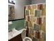 Bathroom features tile walls, a vanity, and shower with patterned curtain at 3127 Latona Sw Dr, Atlanta, GA 30354