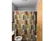 Bathroom features tile walls, a vanity, and shower with patterned curtain at 3127 Latona Sw Dr, Atlanta, GA 30354