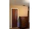 Bedroom with wooden dresser and damaged door at 3127 Latona Sw Dr, Atlanta, GA 30354