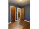 Bedroom featuring a dark blue accent wall and multiple doors at 3127 Latona Sw Dr, Atlanta, GA 30354