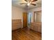 Bedroom with ceiling fan, wooden floor, mirror, dresser, and bed at 3127 Latona Sw Dr, Atlanta, GA 30354