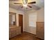 Bedroom with ceiling fan, window, wooden floor, dresser, and armoire at 3127 Latona Sw Dr, Atlanta, GA 30354