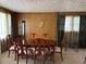 Dining room showcasing classic furniture, wood paneling, and natural light from a window at 3127 Latona Sw Dr, Atlanta, GA 30354