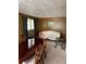 Traditional dining room with wood paneling, patterned wallpaper, and elegant dining set at 3127 Latona Sw Dr, Atlanta, GA 30354