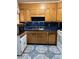 Efficient kitchen featuring oak cabinets and easy-to-clean tile flooring at 3127 Latona Sw Dr, Atlanta, GA 30354