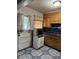 Compact kitchen with window view, wood cabinets and blue countertops at 3127 Latona Sw Dr, Atlanta, GA 30354
