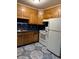 Functional kitchen with wood cabinets, blue countertops, and essential appliances at 3127 Latona Sw Dr, Atlanta, GA 30354