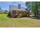 The brick home displays a screened-in porch and a view of a spacious, manicured backyard at 415 Stephanie Ct, Stockbridge, GA 30281