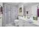 Bright bathroom featuring neutral walls and floral shower curtain at 415 Stephanie Ct, Stockbridge, GA 30281