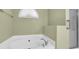 Bright bathroom features a relaxing soaking tub under an arch window at 415 Stephanie Ct, Stockbridge, GA 30281