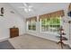Well-lit bedroom with dual windows, neutral walls, and carpeting at 415 Stephanie Ct, Stockbridge, GA 30281