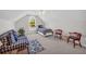 Upstairs bonus room with dormer window, ceiling fan, and cozy seating areas at 415 Stephanie Ct, Stockbridge, GA 30281