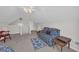 Upstairs bonus room with dormer window, ceiling fan, and cozy seating areas at 415 Stephanie Ct, Stockbridge, GA 30281