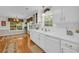 Bright kitchen with white cabinets, long countertops, modern appliances, and large window view at 415 Stephanie Ct, Stockbridge, GA 30281