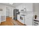 Bright kitchen features white cabinets, long countertops, modern appliances and decorative runner at 415 Stephanie Ct, Stockbridge, GA 30281