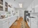 Bright kitchen features white cabinets, long countertops, modern appliances and decorative runner at 415 Stephanie Ct, Stockbridge, GA 30281