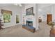 Bright living room featuring a brick fireplace with mantel and large windows letting in natural light at 415 Stephanie Ct, Stockbridge, GA 30281