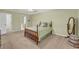 Spacious bedroom with a tray ceiling, fan, and ample closet space at 415 Stephanie Ct, Stockbridge, GA 30281