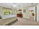 Open bedroom with abundant natural light, fan, and attached seating area at 415 Stephanie Ct, Stockbridge, GA 30281