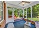 Enclosed sunroom with brick base, large windows overlooking the backyard at 415 Stephanie Ct, Stockbridge, GA 30281